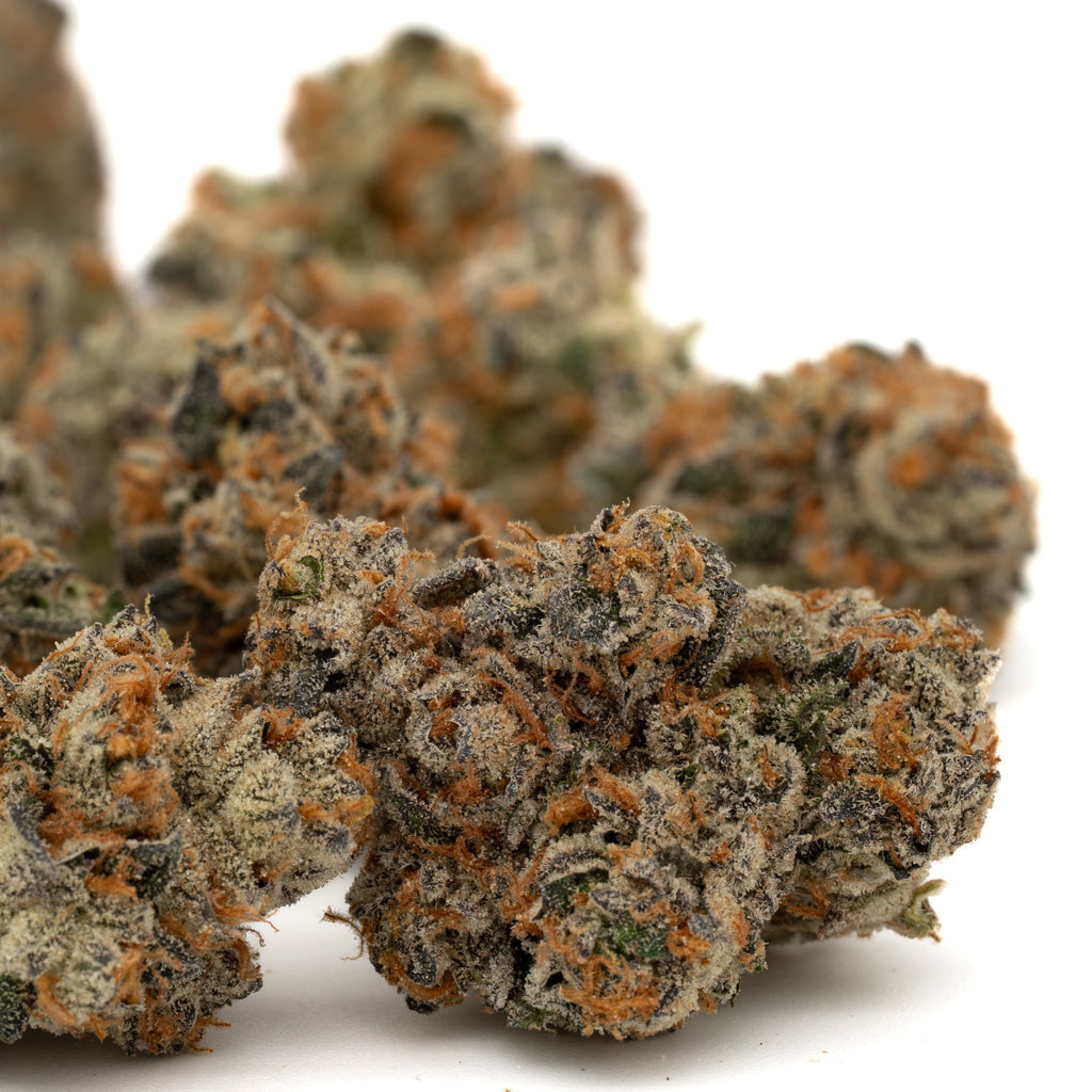 Dense Cadillac Rainbow THCa Indoor Flower buds with orange hairs and Orchard Swirl synergy