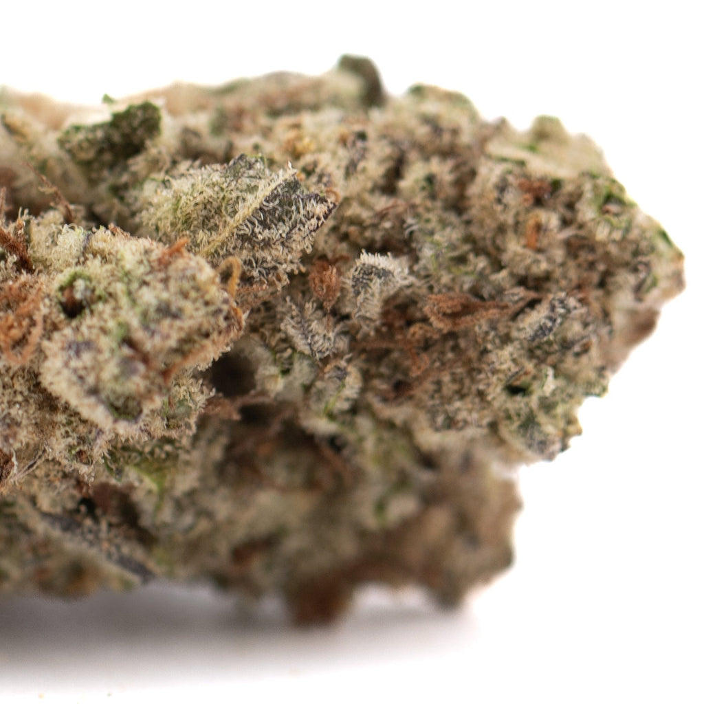 Green cannabis bud with white trichomes and pink hues from Greenhouse for Purple Pop Rocks